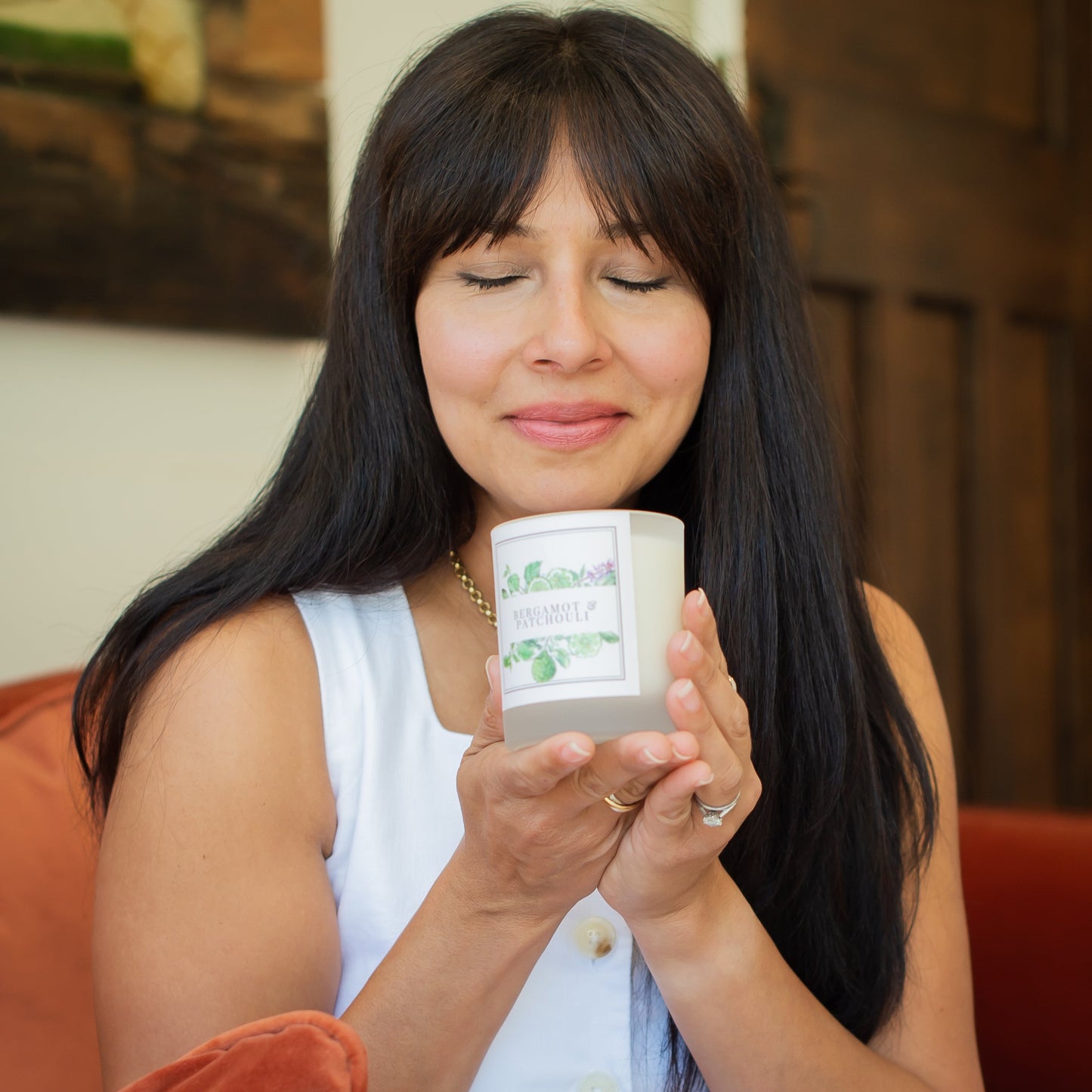 Woman holding a Bergamot and Patchouli candle