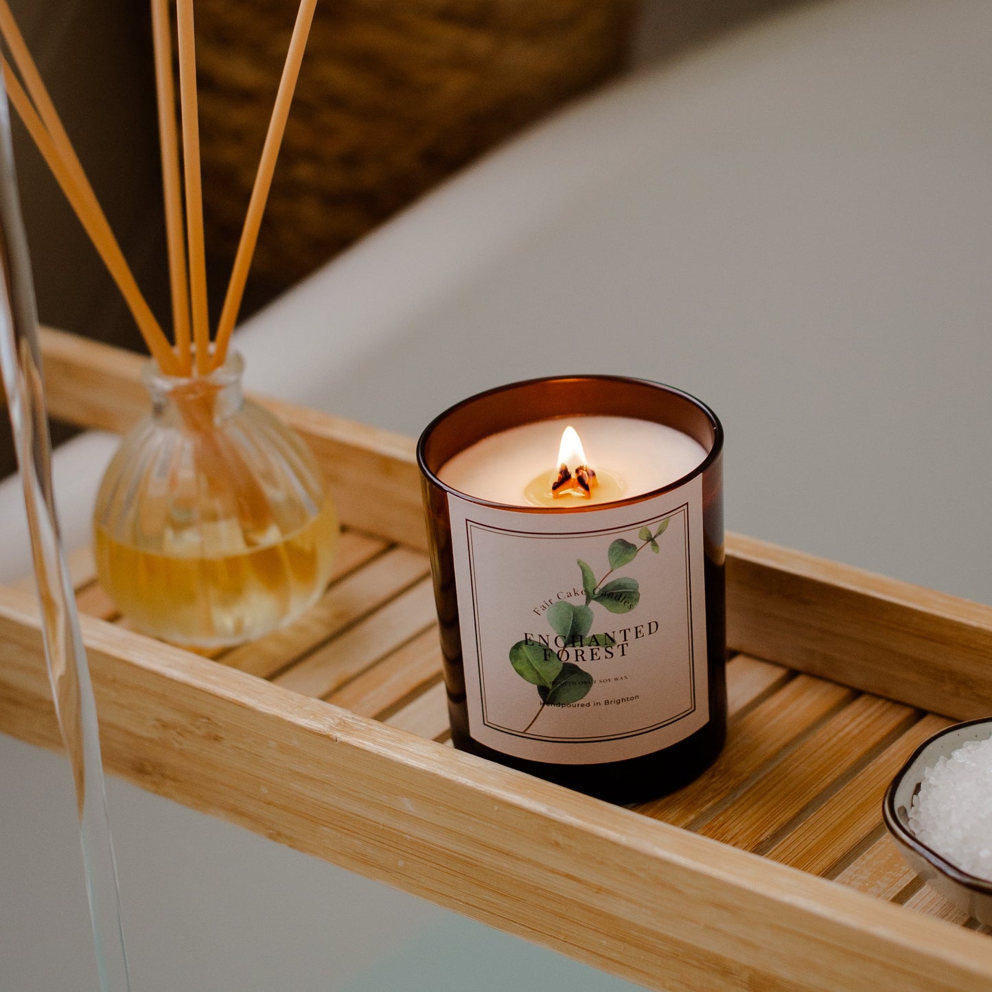 Enchanted Forest Candle lit in a bathroom. Hand poured in Brighton.