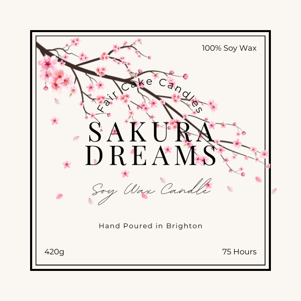 Label of a Sakura Dreams soy wax candle, depicting a branch of cherry blossoms and product details such as weight and burn time.