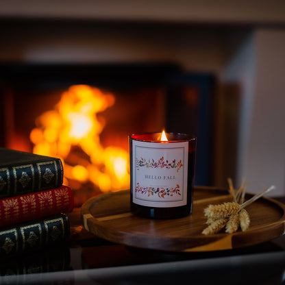 Hello Fall autumnal Candle in a glass jar with a fireplace in the background